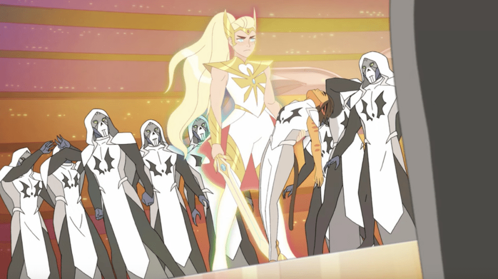 adora wearing the new she-ra outfit and holding catra